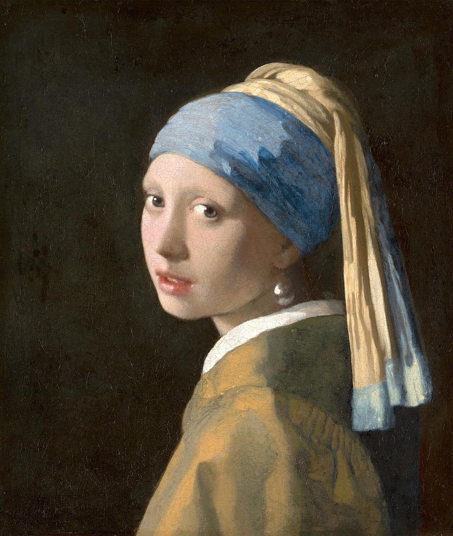 A young woman in a blue-and-yellow turban turns toward the viewer against a dark background, wearing a large, bright earring.